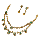 Gold necklace with green gemstones and matching earrings on a white background