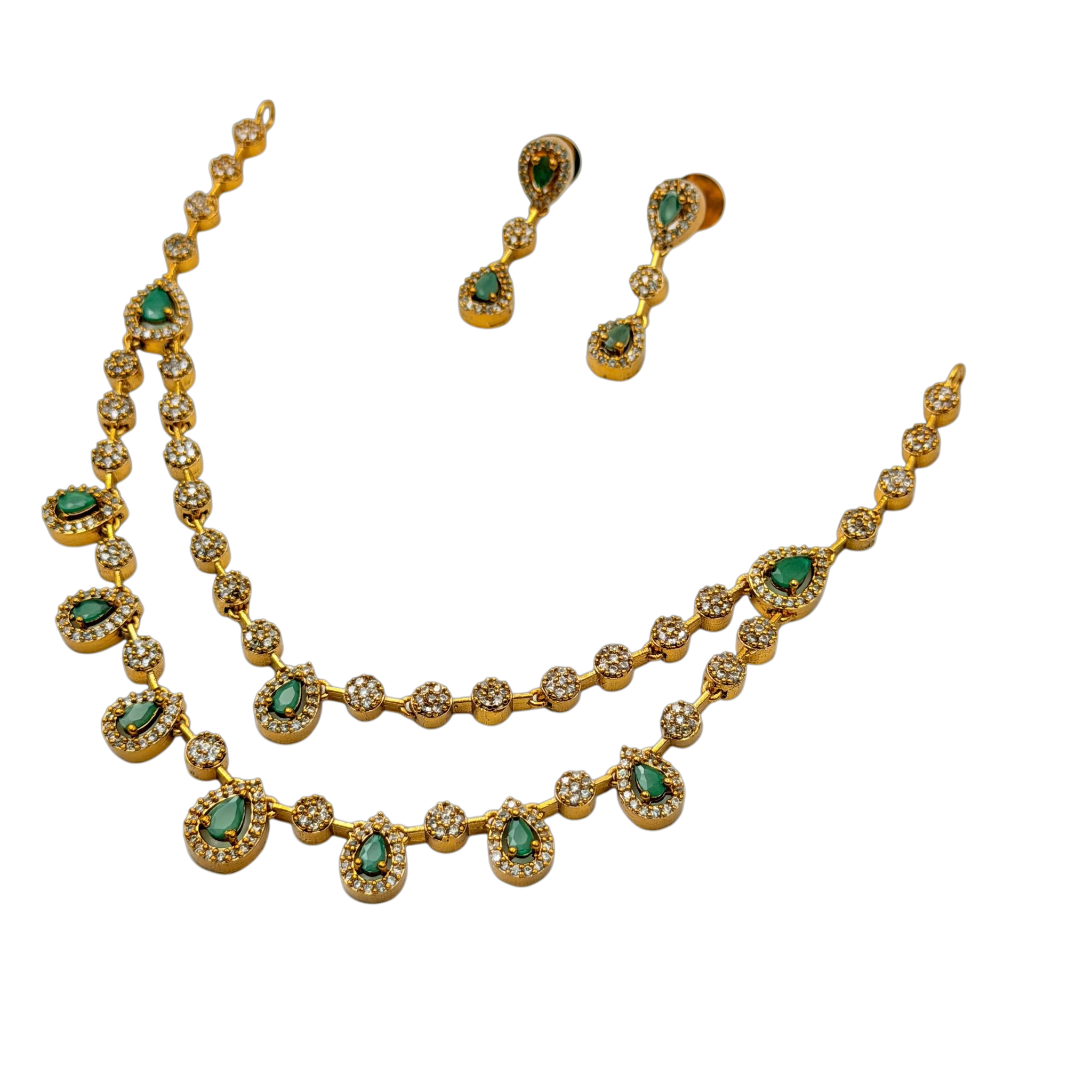 Gold necklace with green gemstones and matching earrings on a white background