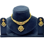 Gold necklace and earrings set on a blue velvet stand