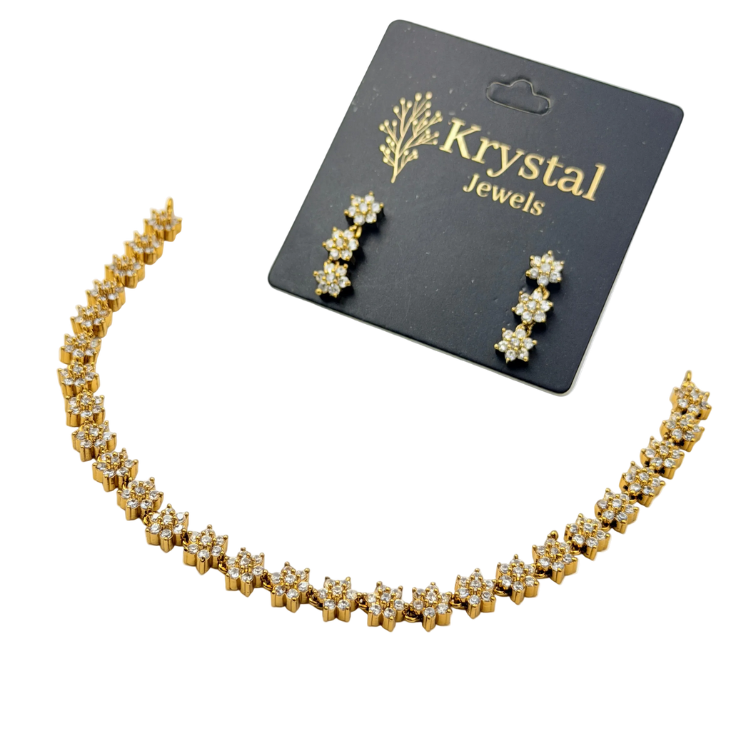 Gold necklace and earrings set with 'Krystal Jewels' card on a white background