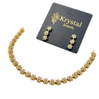 Gold necklace and earrings set with 'Krystal Jewels' card on a white background