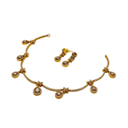 Gold necklace and earrings set on a white background