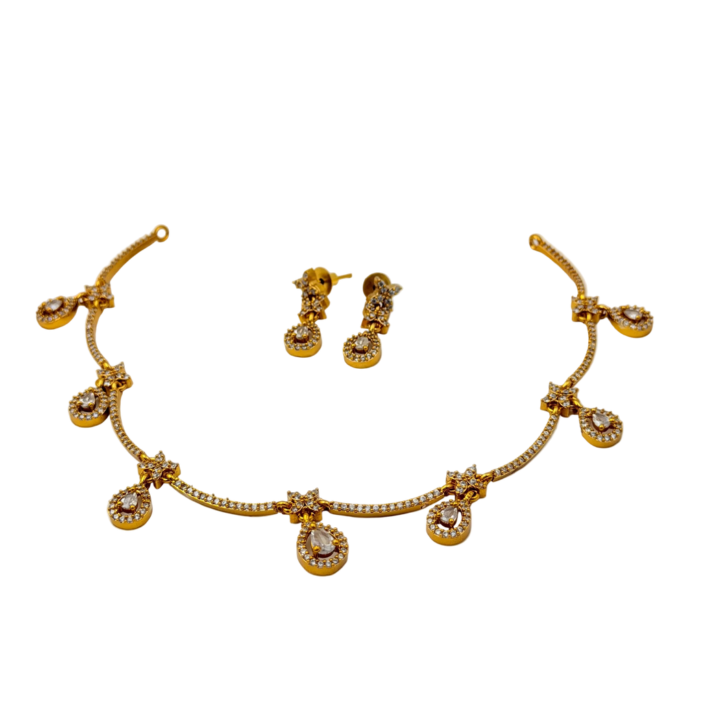 Gold necklace and earrings set on a white background