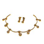 Gold necklace and earrings set on a white background