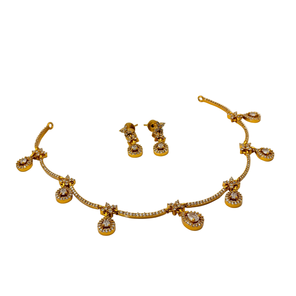 Gold necklace and earrings set on a white background