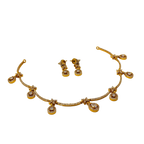 Gold necklace and earrings set on a white background