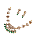 Gold necklace with emeralds and diamonds on a white background