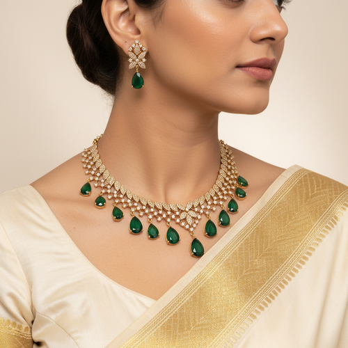 Woman wearing a gold necklace with green gemstones and matching earrings.