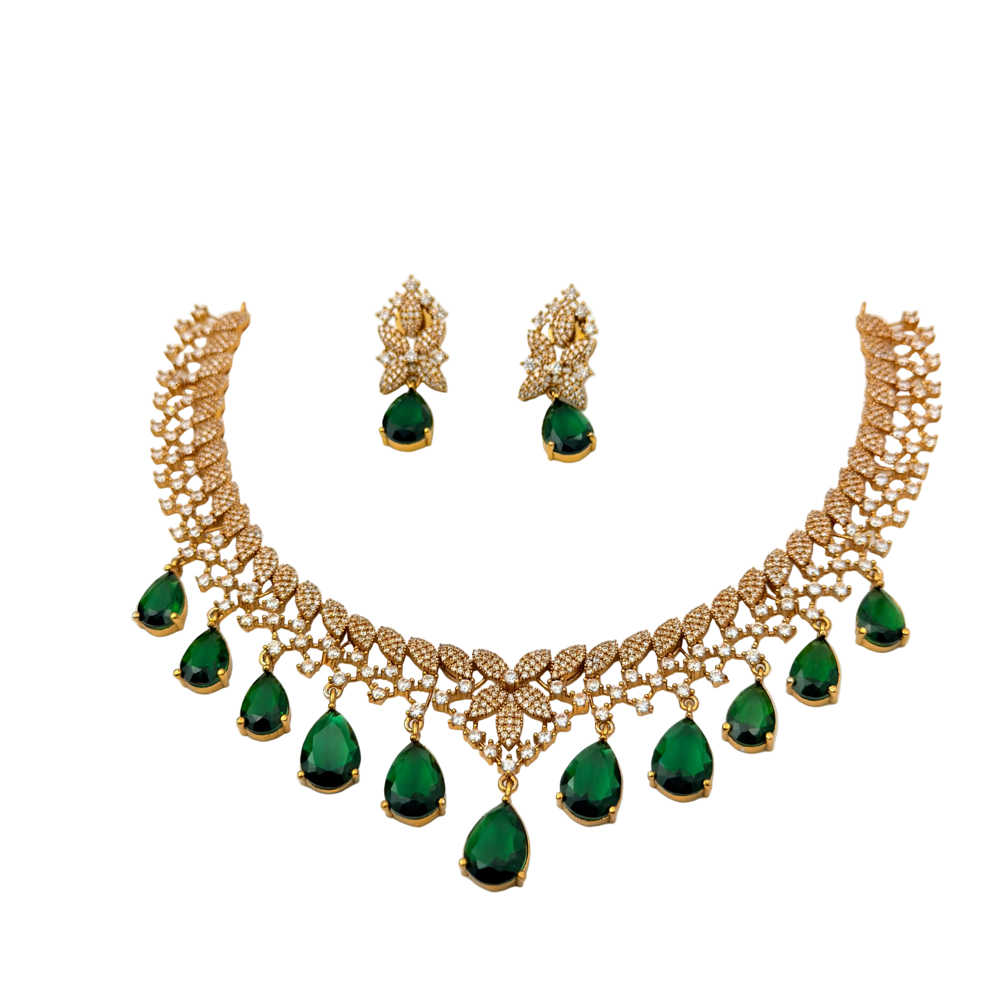 Gold necklace with green gemstones and matching earrings on a white background