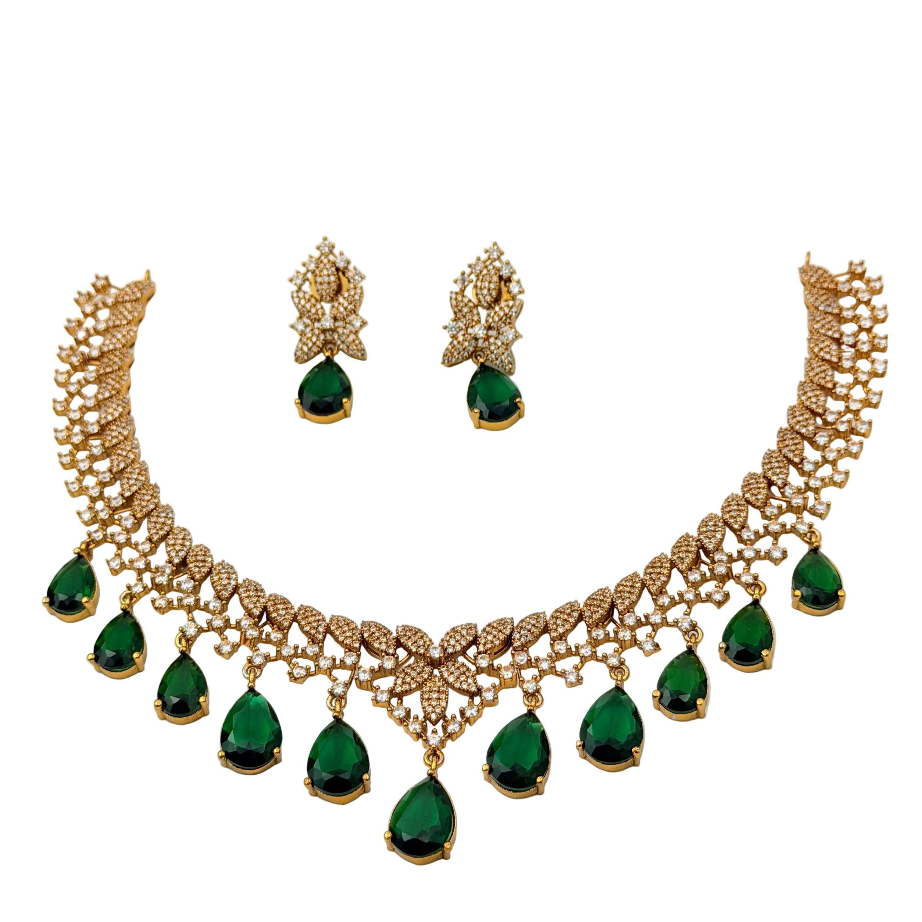 Gold necklace with green gemstones and matching earrings on a white background