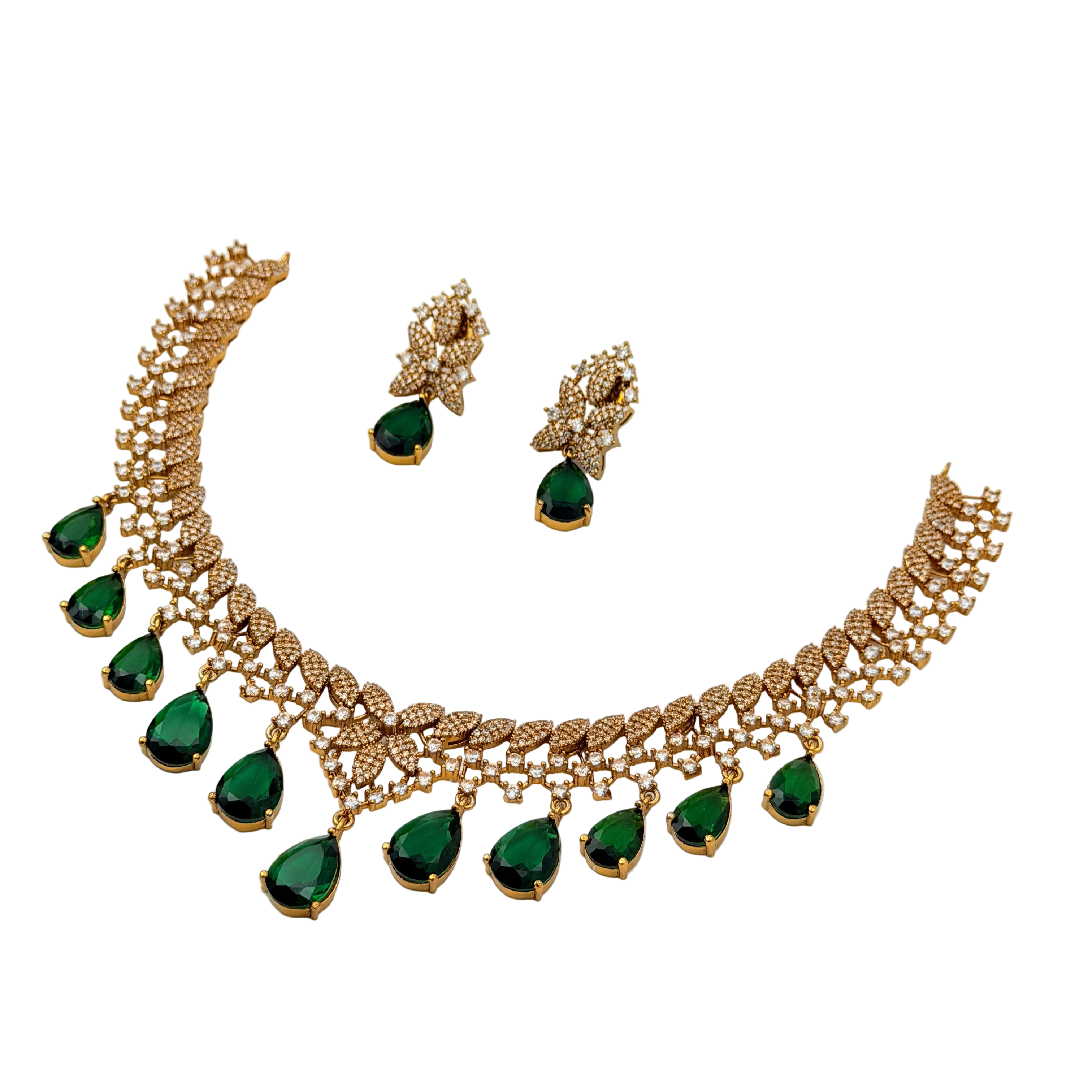 Gold necklace with green gemstones and matching earrings on a white background