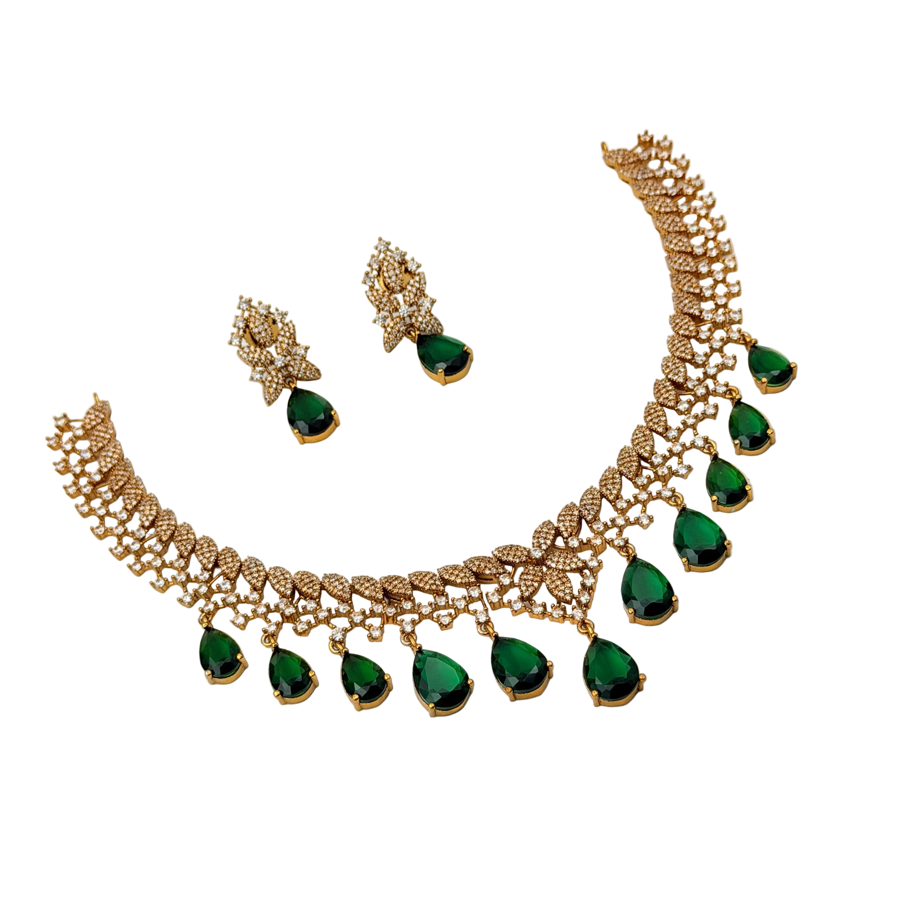 Gold necklace with green gemstones and matching earrings on a white background