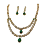 Jewelry set with necklace and earrings featuring green gemstones on a white background