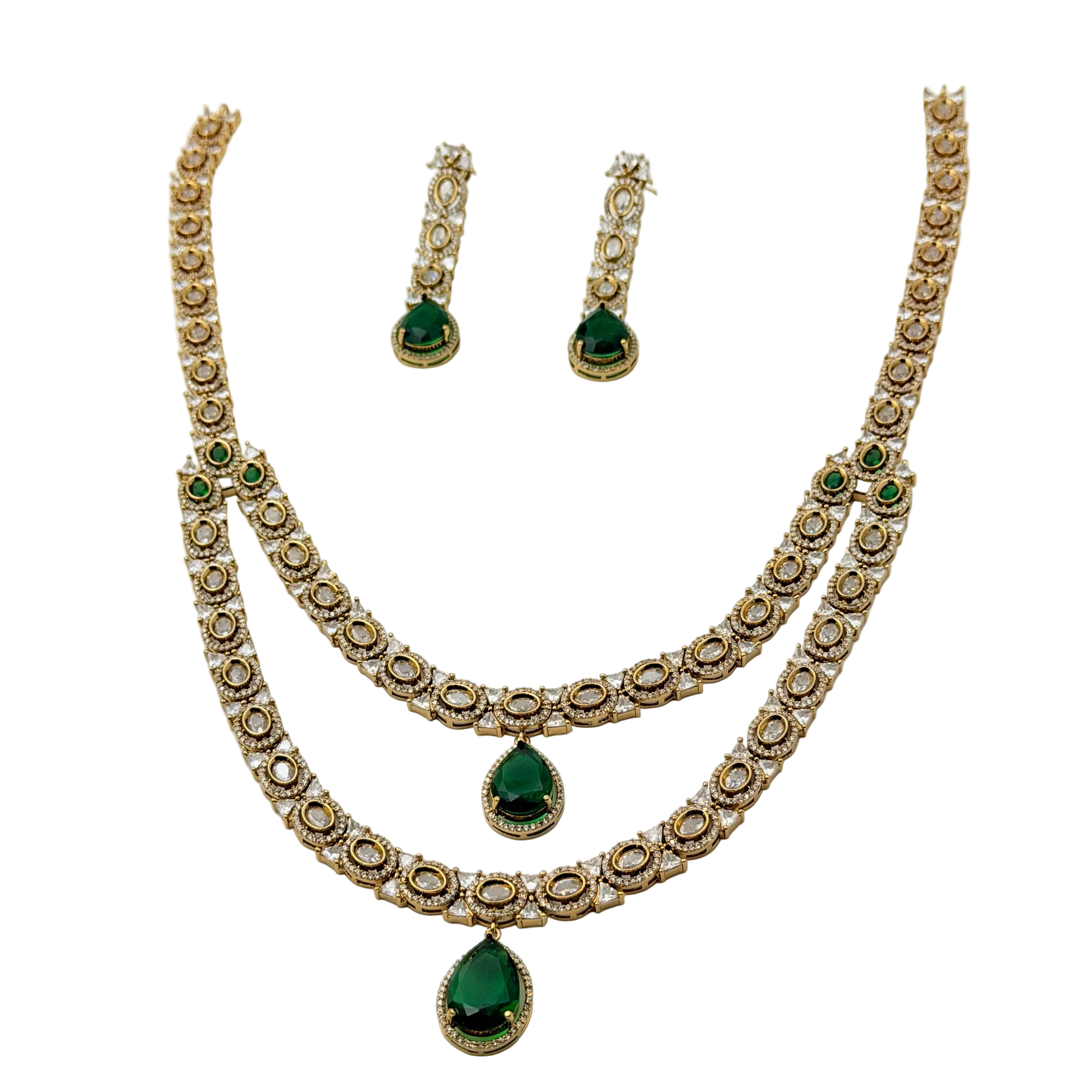 Jewelry set with necklace and earrings featuring green gemstones on a white background