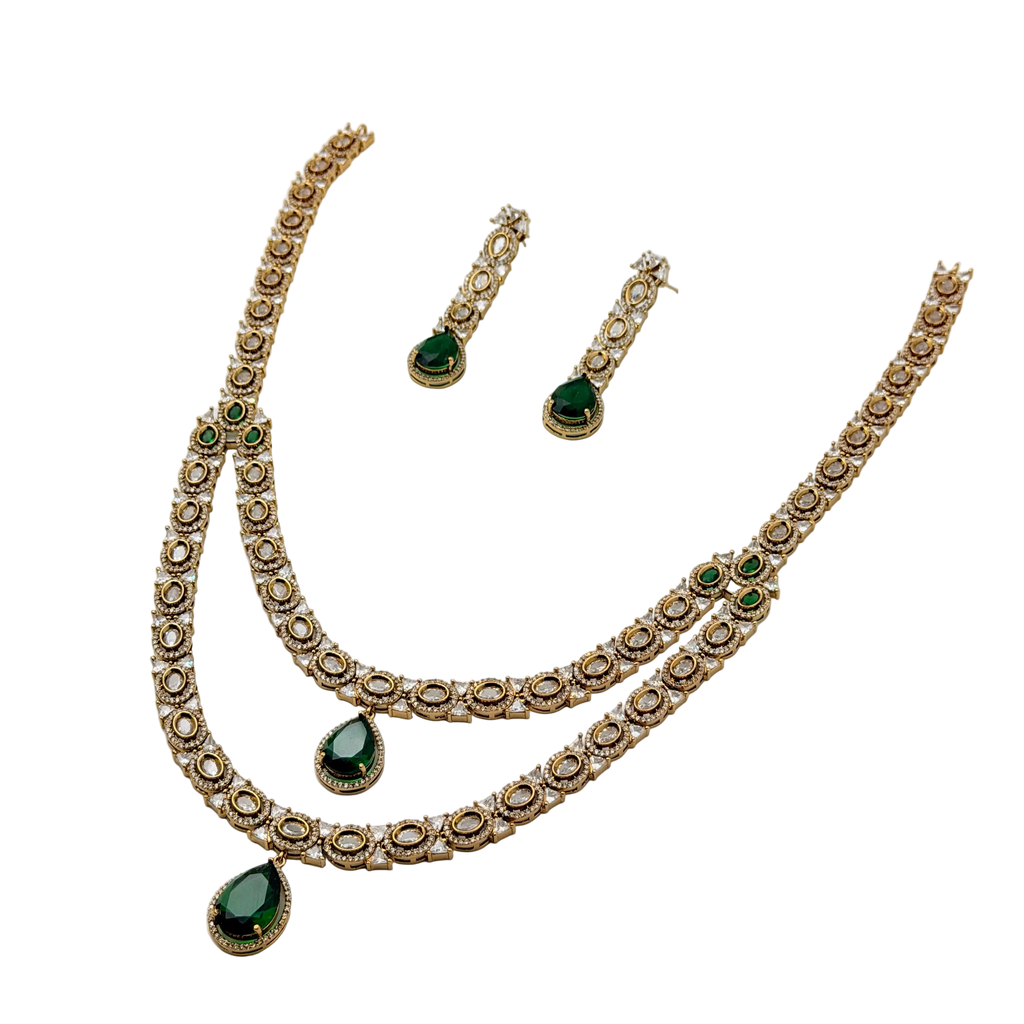Jewelry set with necklace and earrings featuring green stones on a white background