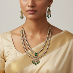 Woman wearing a traditional necklace and earrings with a plain background
