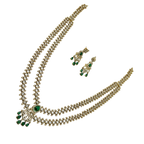Gold necklace with green gemstones and matching earrings on a white background