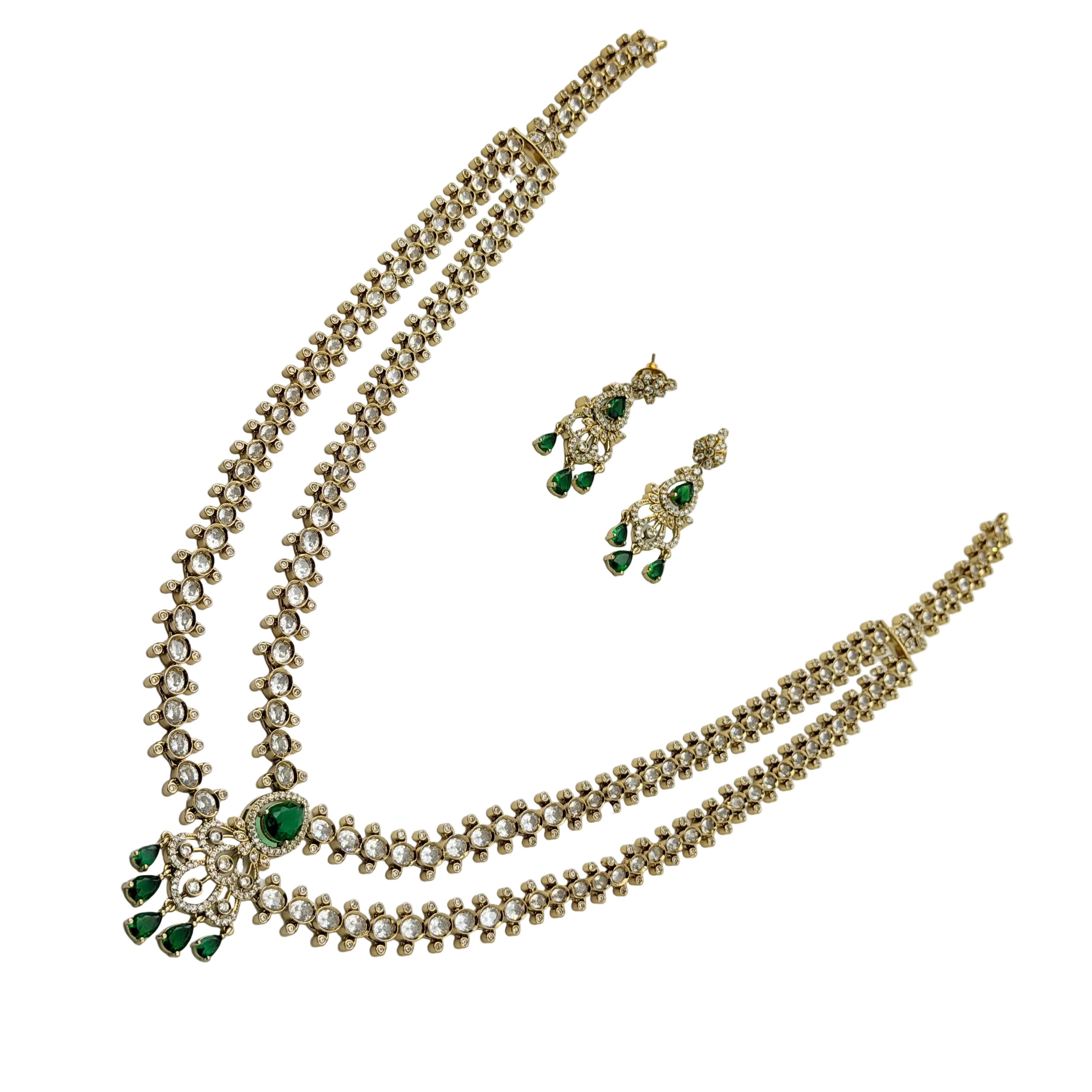 Gold necklace with green gemstones and matching earrings on a white background