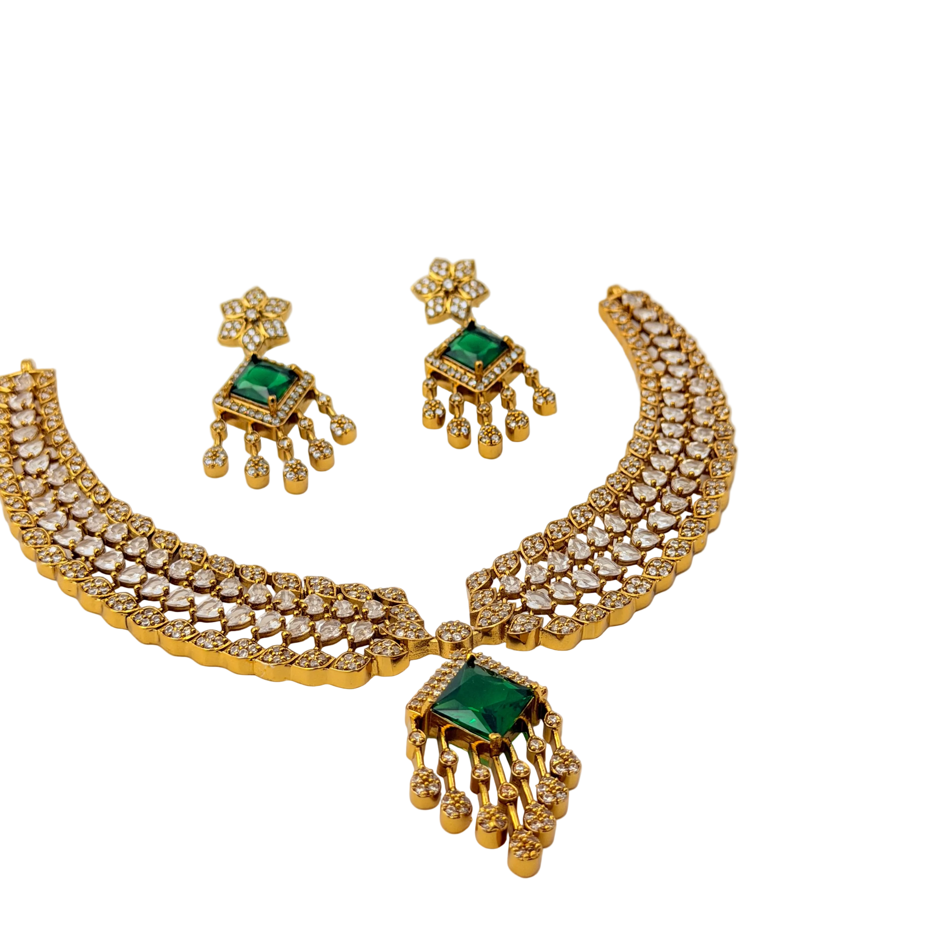 Gold necklace with green gemstones on a white background