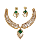 Gold necklace with green gemstones and matching earrings on a white background