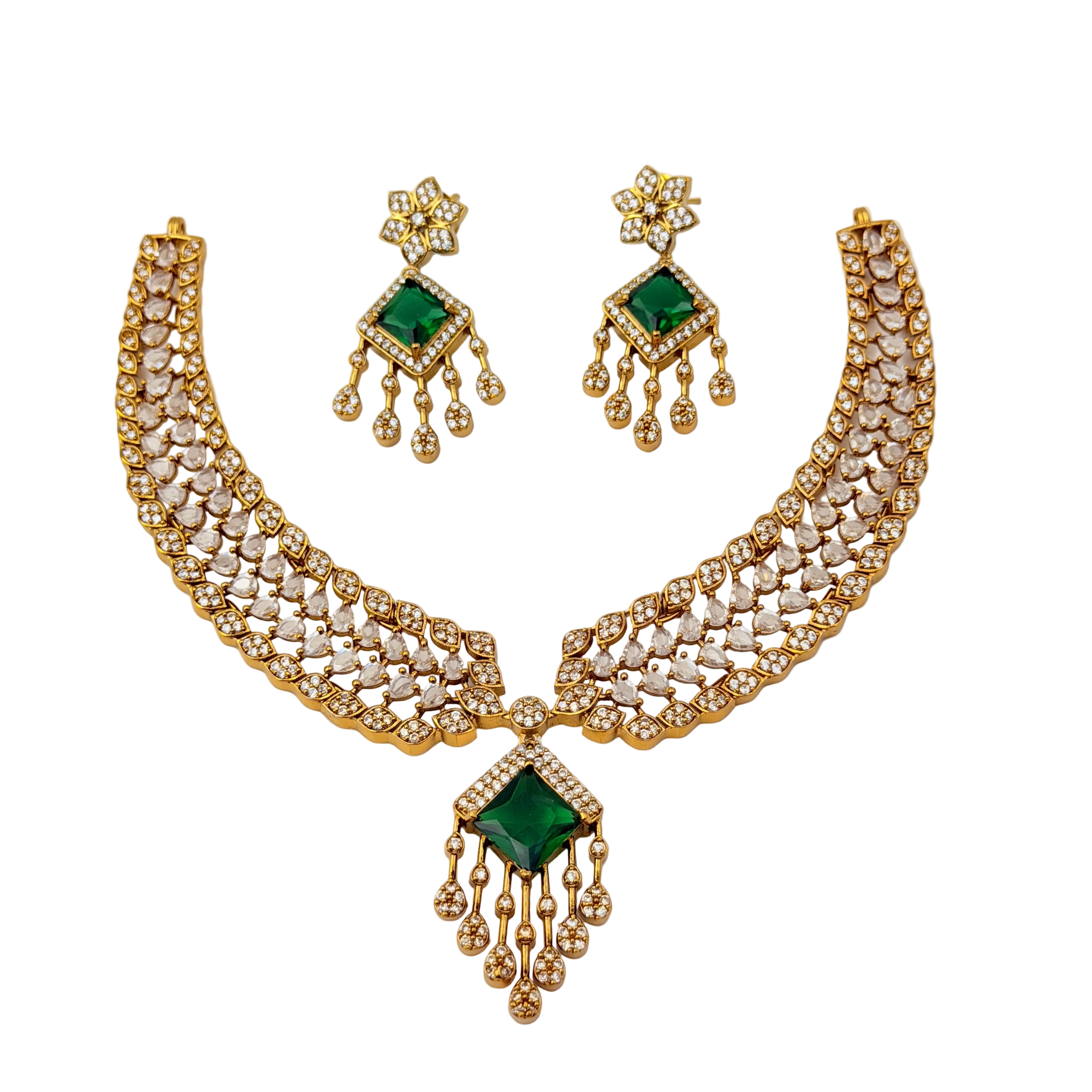 Gold necklace with green gemstones and matching earrings on a white background