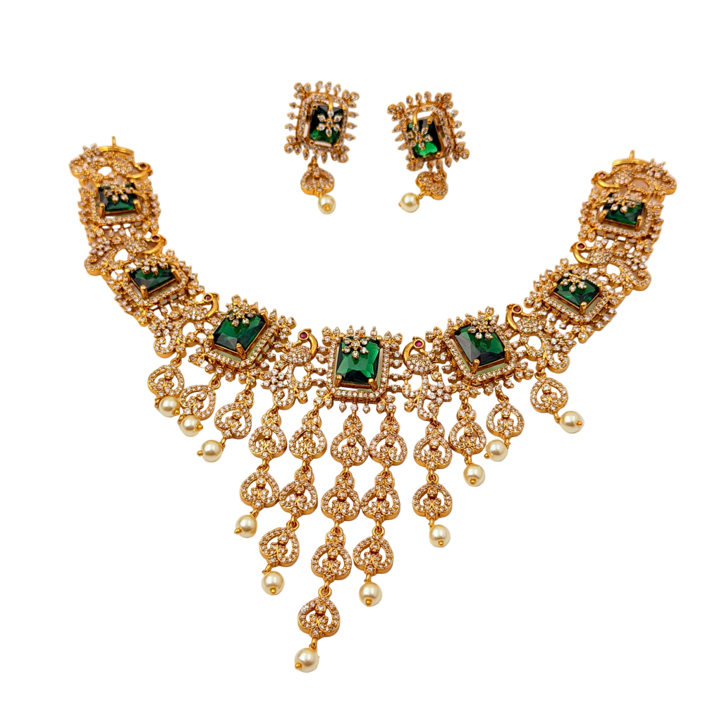 Gold necklace with green gemstones and matching earrings on a white background