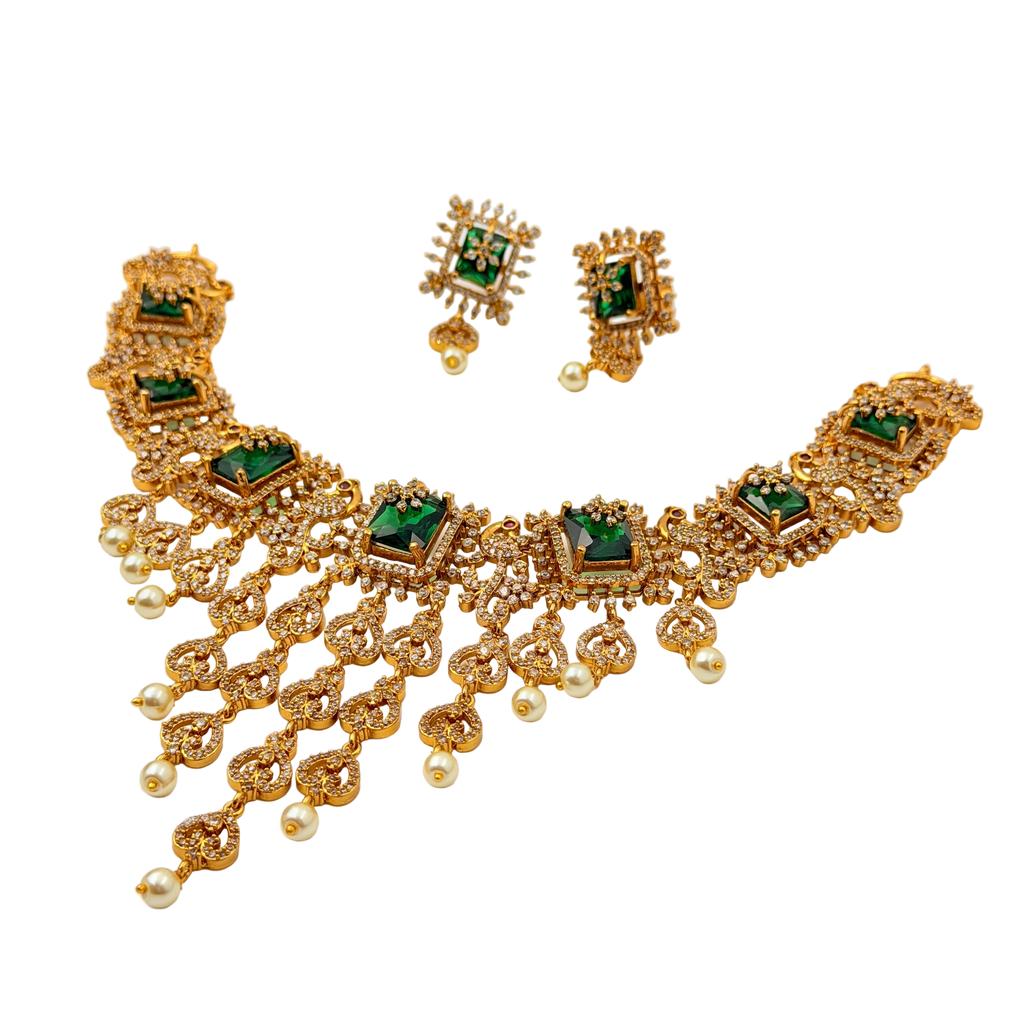 Gold necklace with green gemstones and matching earrings on a white background