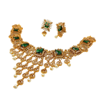 Gold necklace with green gemstones and matching earrings on a white background
