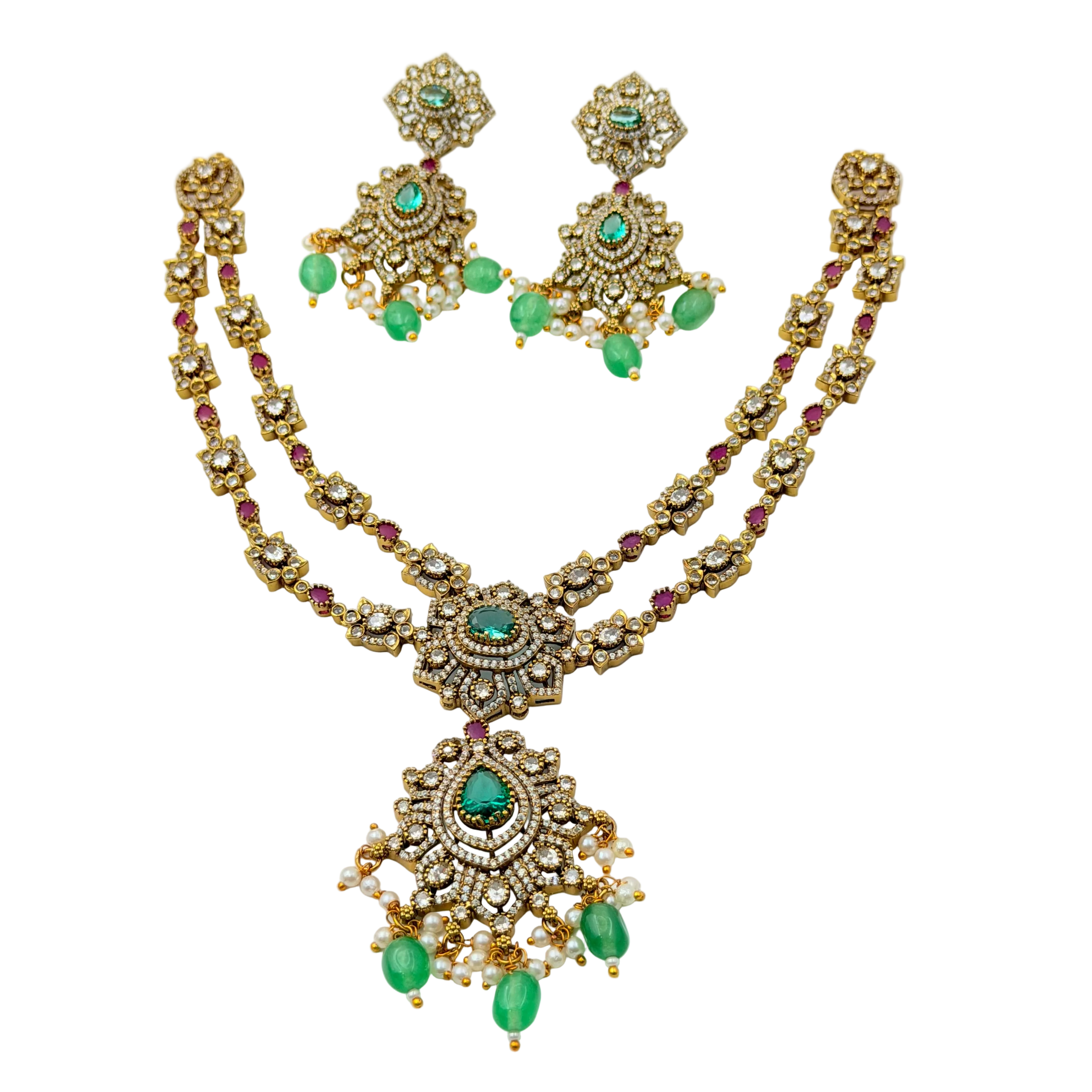Gold necklace with green and red stones on a white background