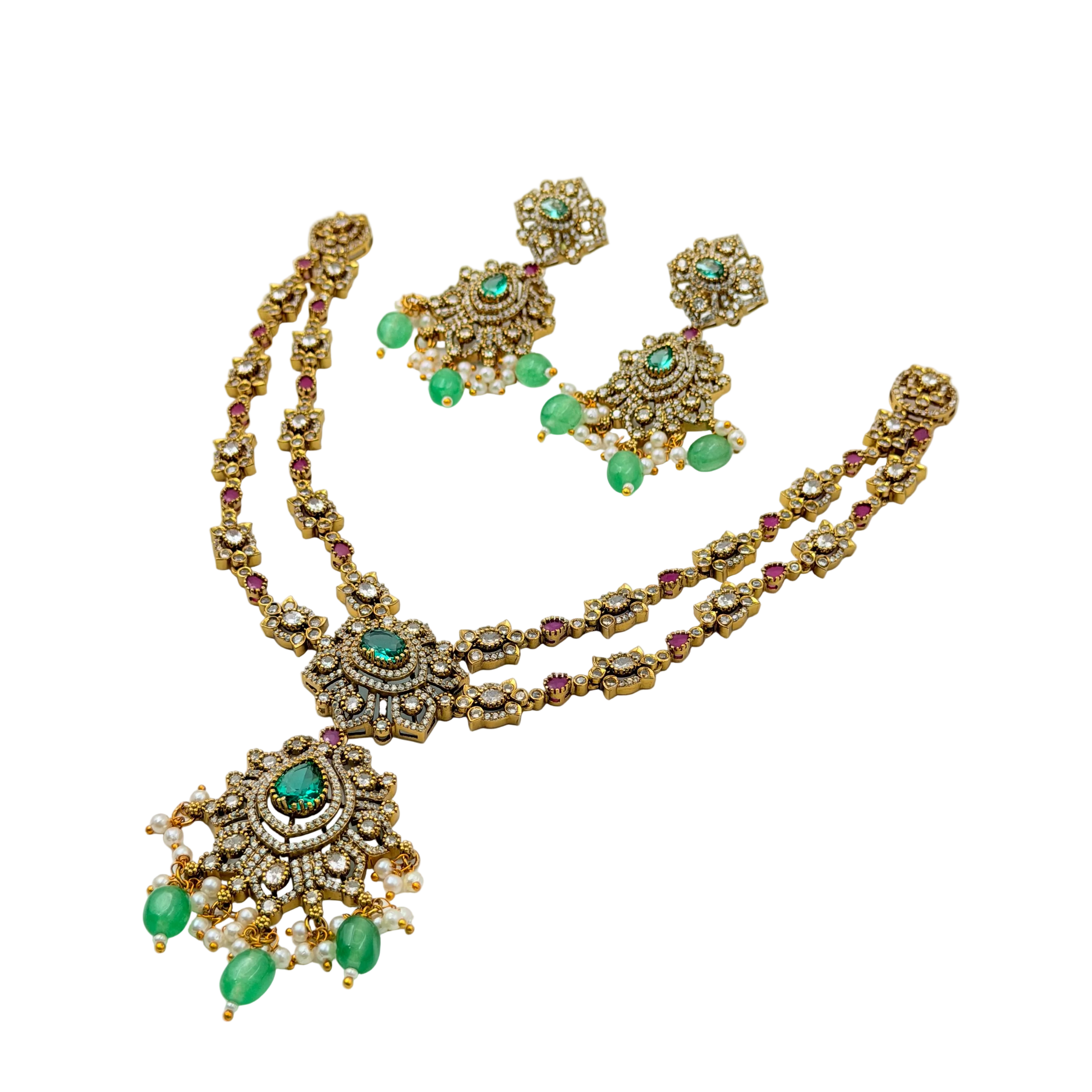 Gold necklace with green gemstones on a white background