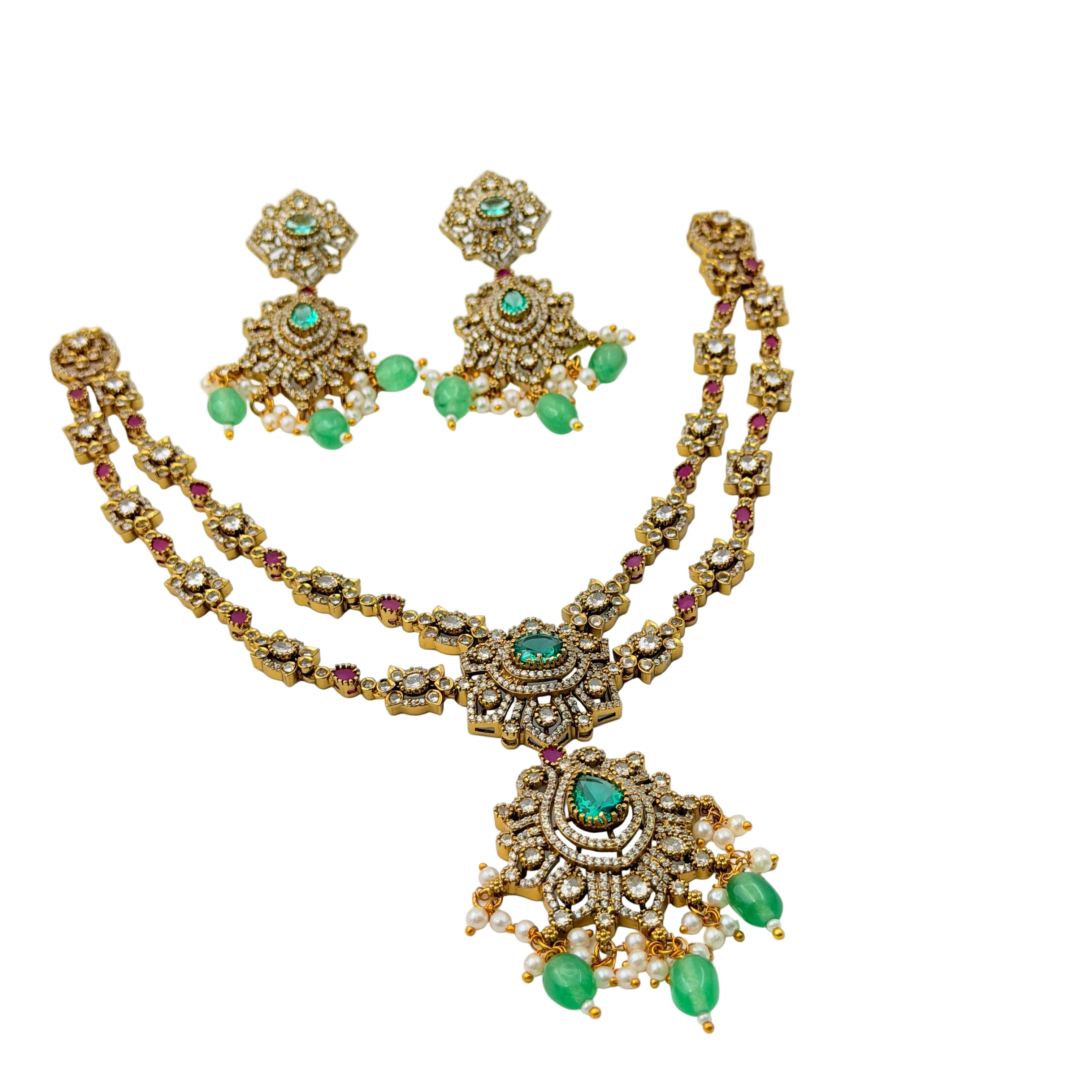 Gold necklace with emeralds and rubies on a white background