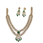 Jewelry set with necklace and earrings featuring green gemstones on a white background
