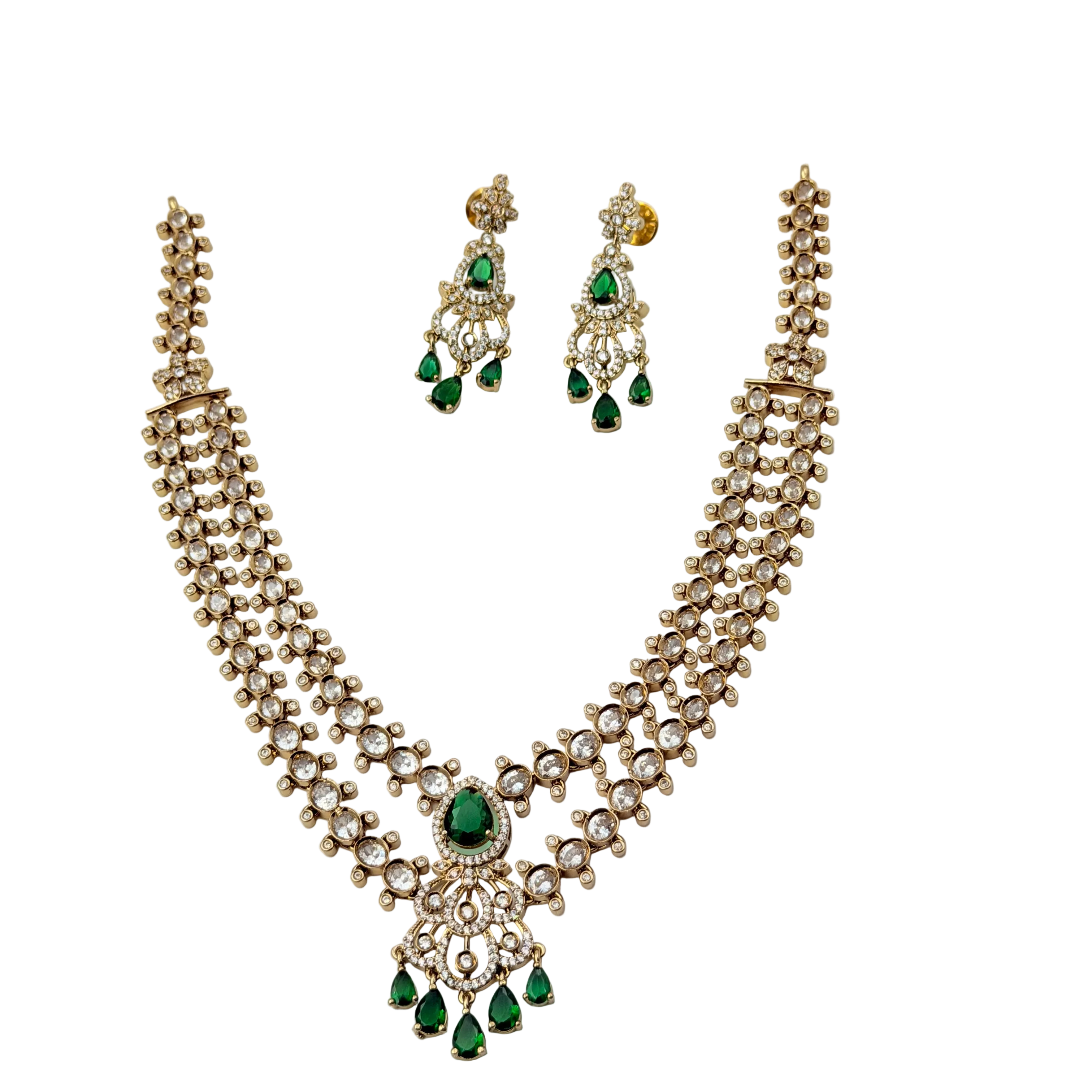 Jewelry set with necklace and earrings featuring green gemstones on a white background