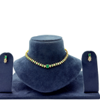 Jewelry set with necklace and earrings on a blue velvet stand against a white background