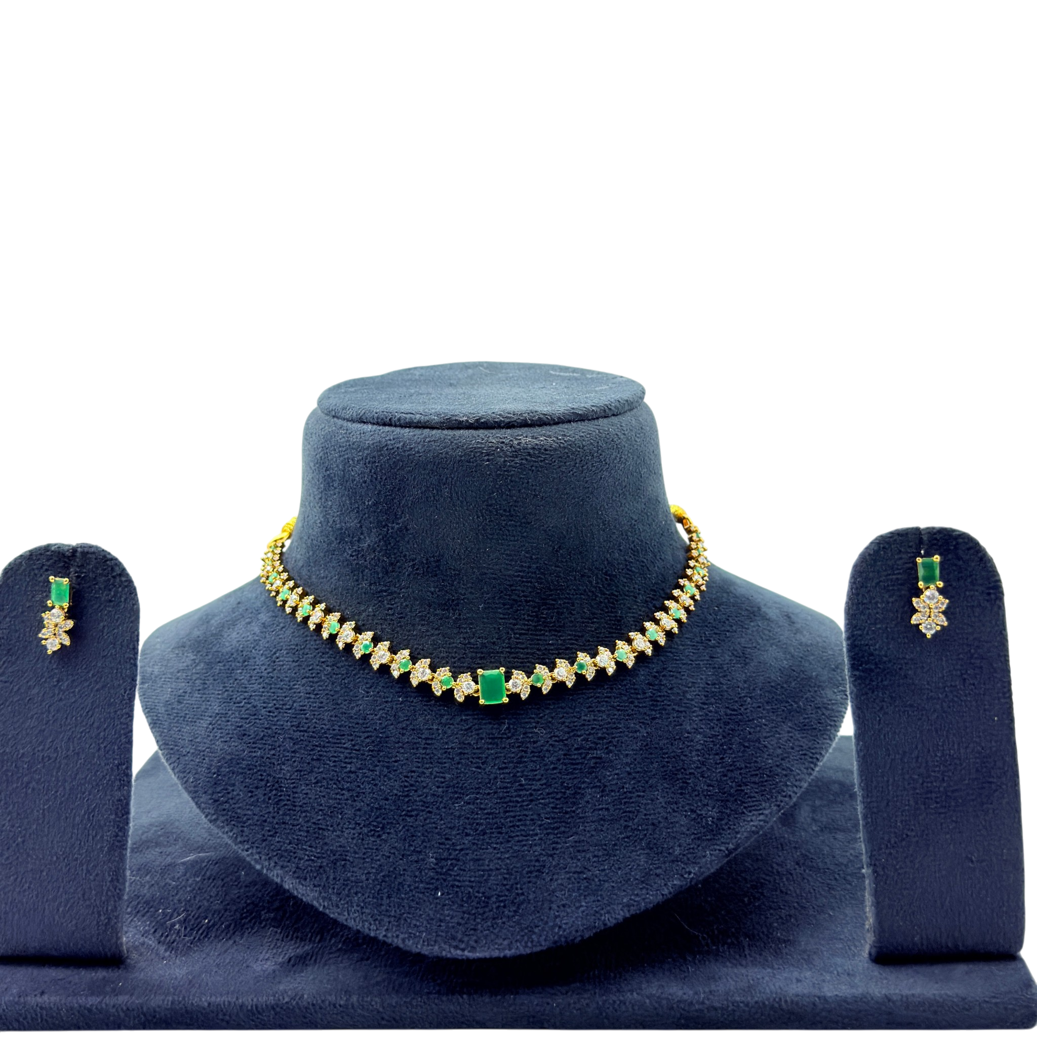 Jewelry set with necklace and earrings on a blue velvet stand against a white background