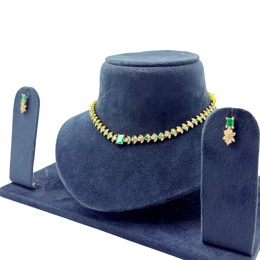 Jewelry set with necklace and earrings on a blue velvet stand