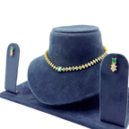 Jewelry set with necklace and earrings on a blue velvet stand