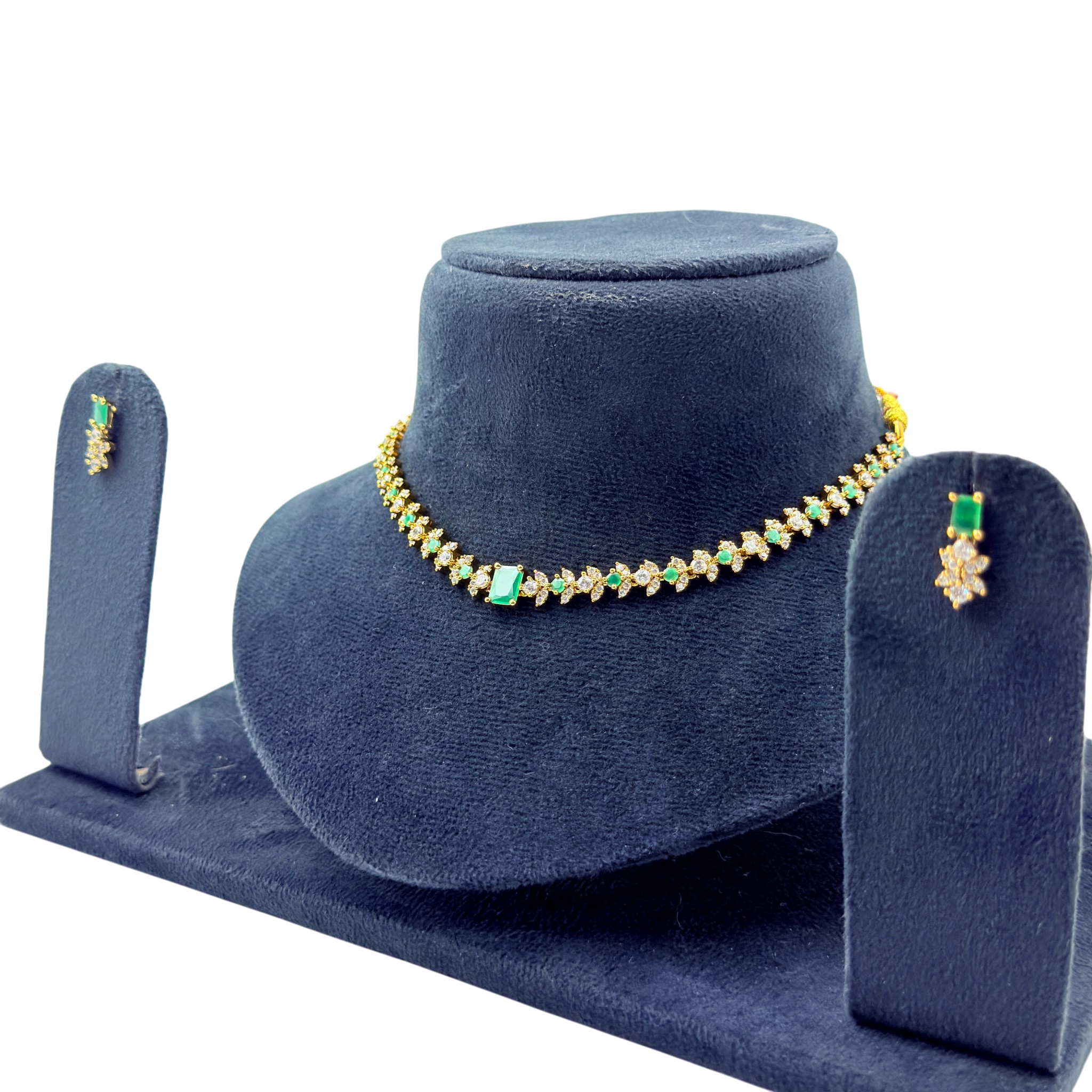 Jewelry set with necklace and earrings on a blue velvet stand
