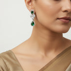 Silver-tone emerald teardrop crystal cluster earring, close-up on model's ear
