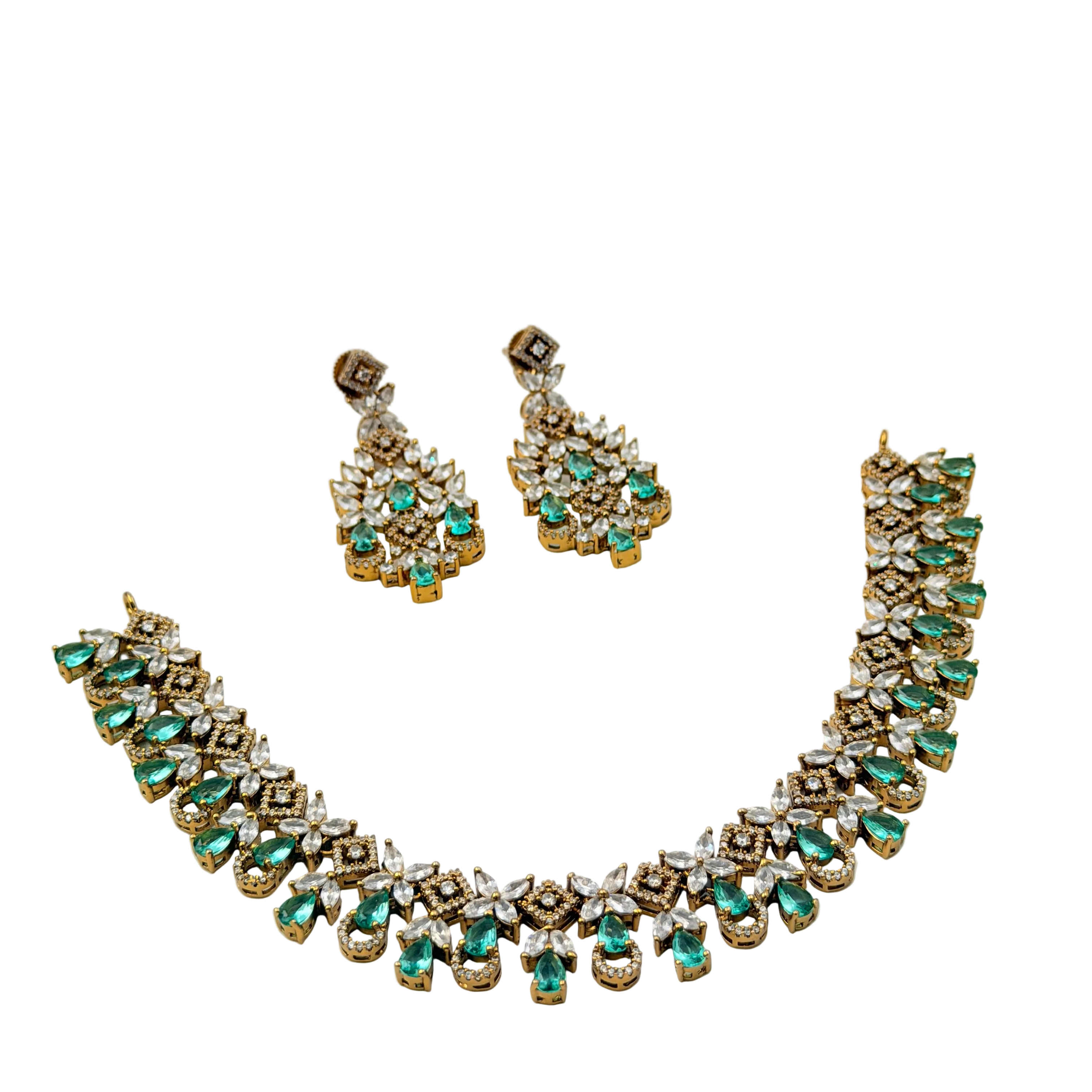 Jewelry set with necklace and earrings featuring green gemstones on a white background