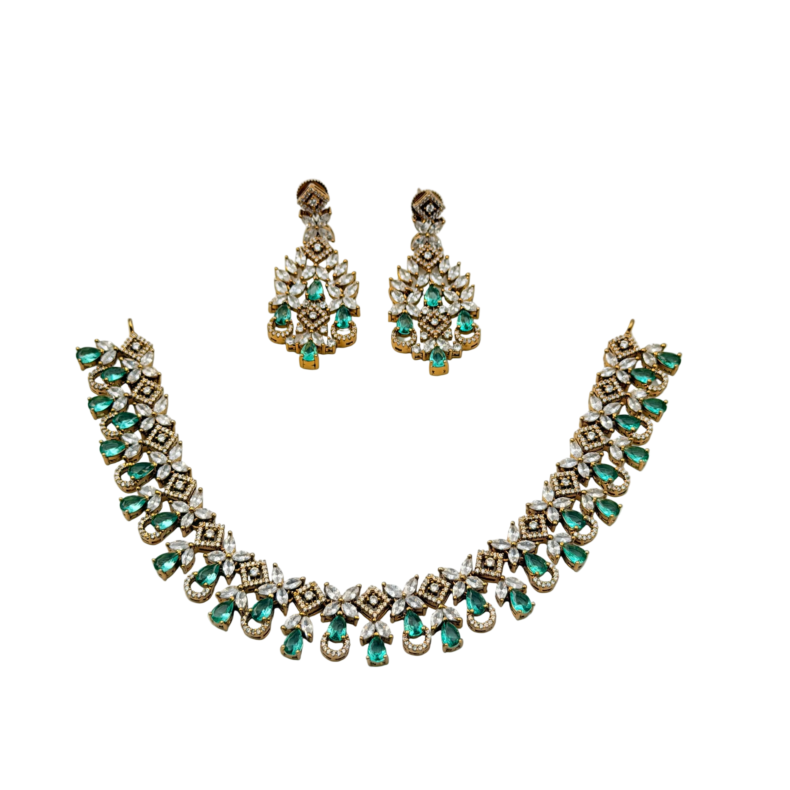 Jewelry set with necklace and earrings featuring green gemstones on a white background