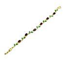 Gold bracelet with green and red gemstones on a white background