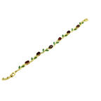 Gold bracelet with green and red gemstones on a white background