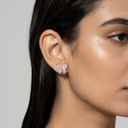 Gold-tone butterfly stud earring with marquise crystal wings, shown worn on ear