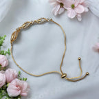Gold-plated marquise-link bracelet studded with American Diamonds, worn on wrist poolside