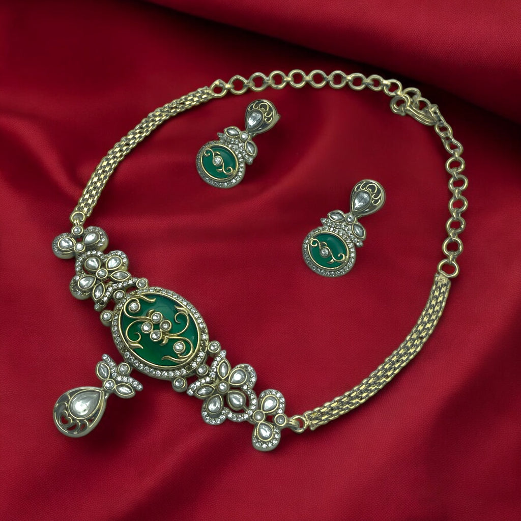 Antique gold Kundan necklace set with green stone centrepiece and white stones, worn on model with matching drop earrings