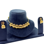 Gold necklace and earrings set on a blue velvet stand