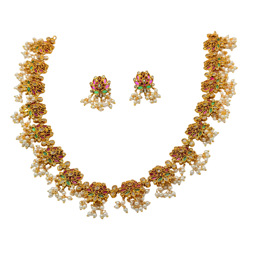 Gold necklace with pearl and gemstone accents on a transparent background