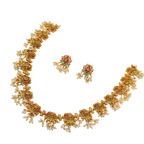 Gold necklace and earrings set on a white background