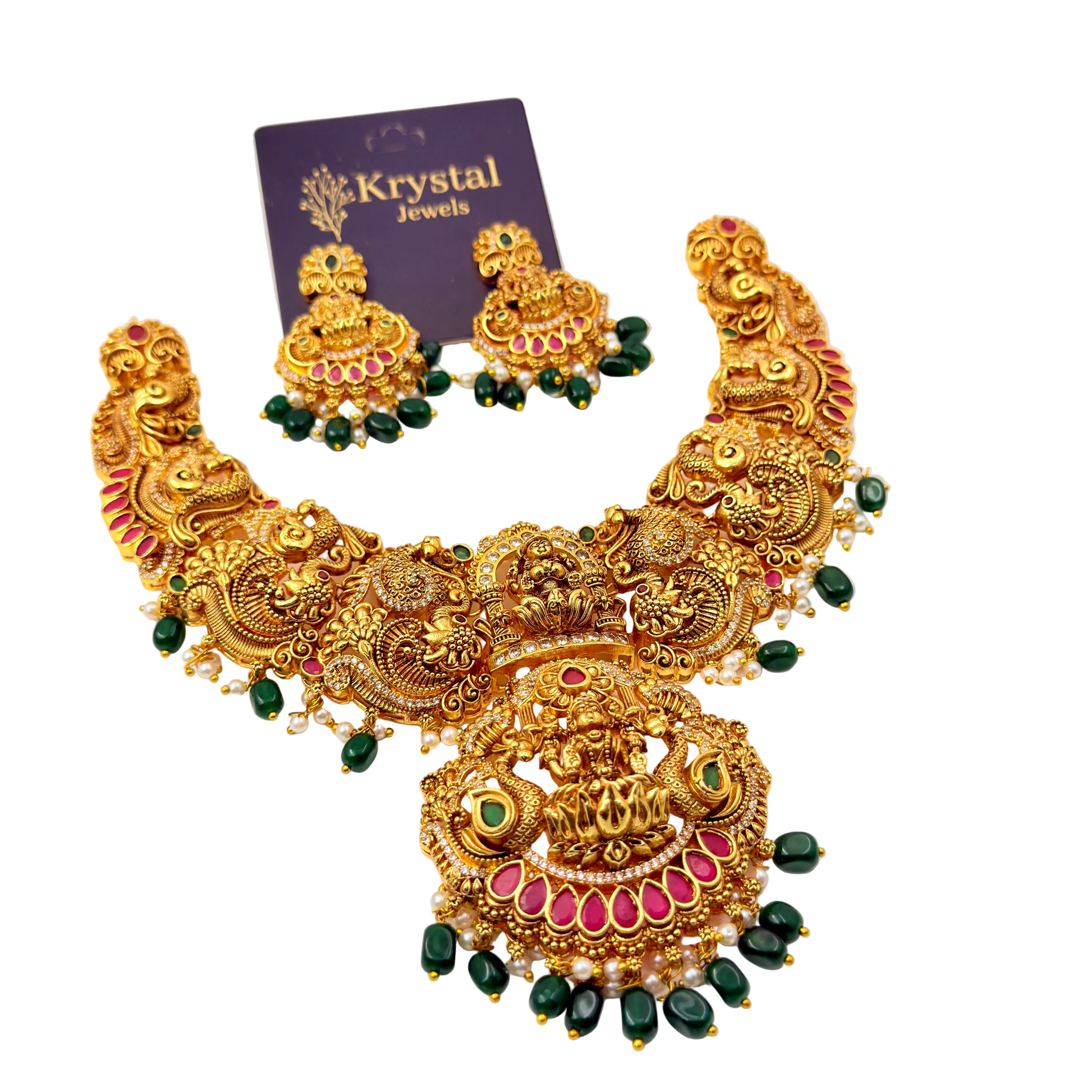 Ornate gold necklace with green and red accents on a white background, featuring Krystal Jewels packaging.
